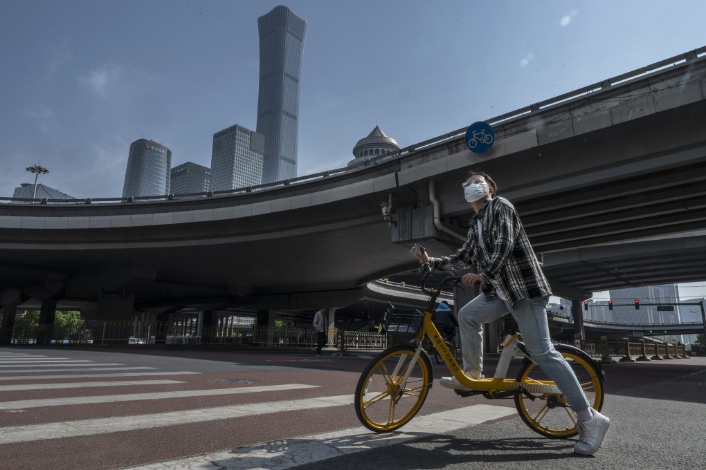 A cyclist stops at a quiet intersection in Beijing’s Central Business District, after the government recommended people work from home to prevent the spread of Covid-19, on May 5. Photo: Getty Images/TNS