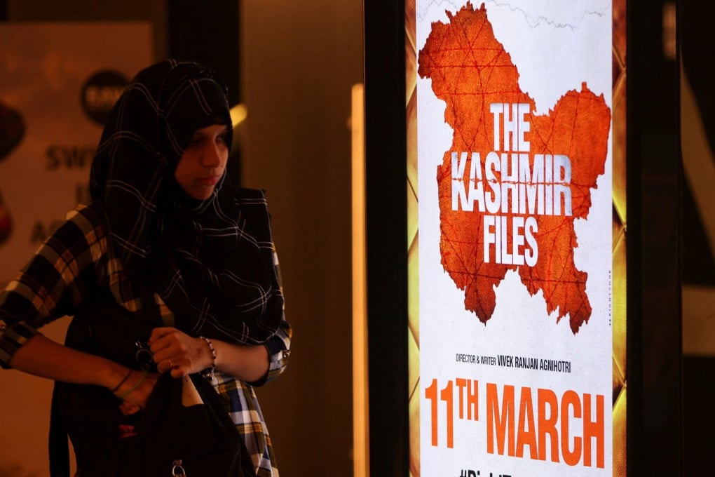 A girl walks past a poster for ‘The Kashmir Files’ inside a cinema in Mumbai earlier this year. Singapore refused to screen the film for its ‘provocative and one-sided portrayal of Muslims and the depictions of Hindus being persecuted’. Photo: Reuters