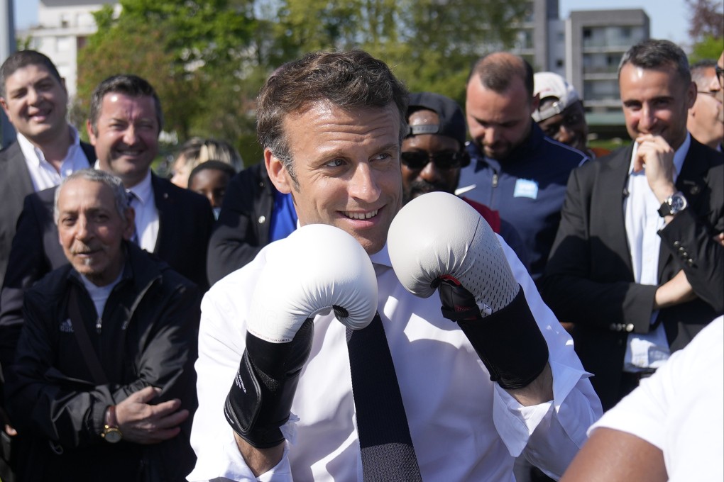 French President Emmanuel Macron wears boxing gloves as he campaigns in the Auguste Delaune stadium, in Saint-Denis, on April 21. Any bold EU transformation must have strong Franco-German backing. Photo: AP