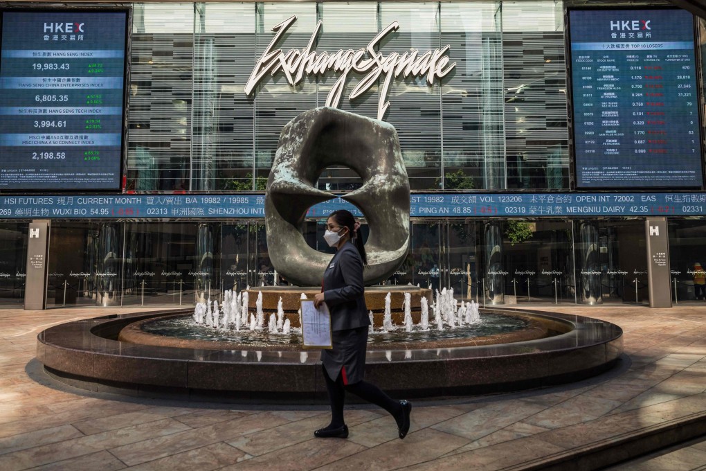A woman walks past Exchange Square which houses the Hong Kong stock exchange. Photo: AFP