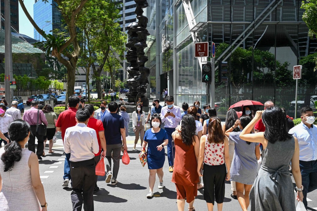 Office workers out for lunch break near Raffles Place in Singapore’s business district on May 10, 2022. Photo: AFP