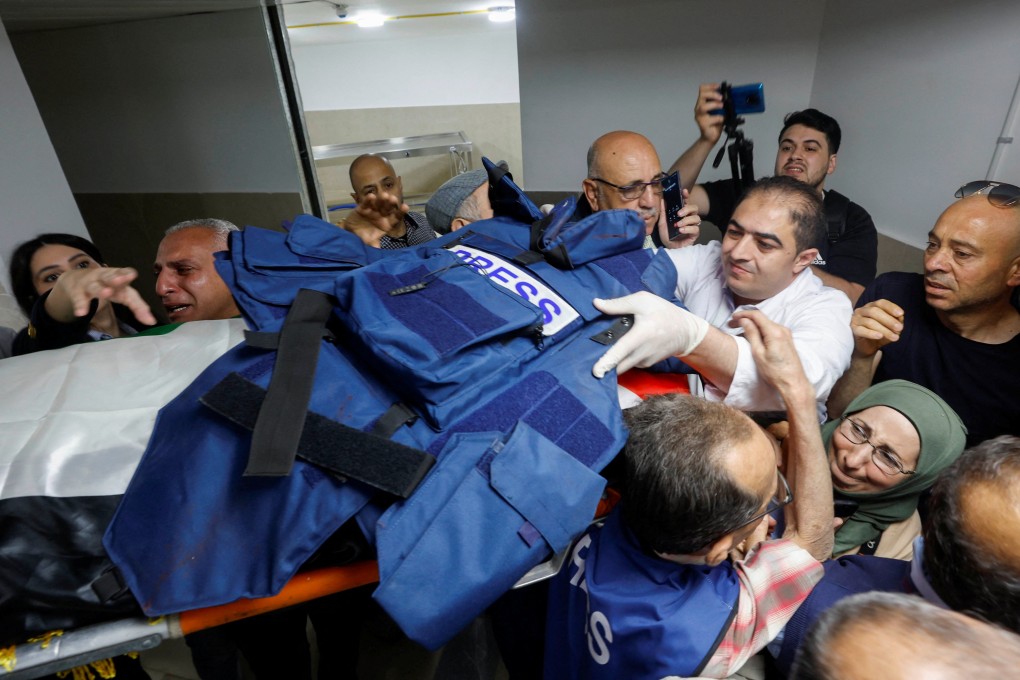 Mourners, including journalists, carry the body and flak jacket of Al Jazeera reporter Shireen Abu Aqleh, who was killed during an Israeli raid in Jenin in the Israeli-occupied West Bank. Photo: Reuters