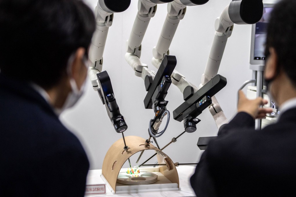 Visitors look at a Kawasaki Heavy Industries Ltd. medical robot at an exhibition in Tokyo earlier this year. Japan’s economic security bill aims to guard technology and  impose tighter oversight of firms working in sensitive sectors. Photo: AFP