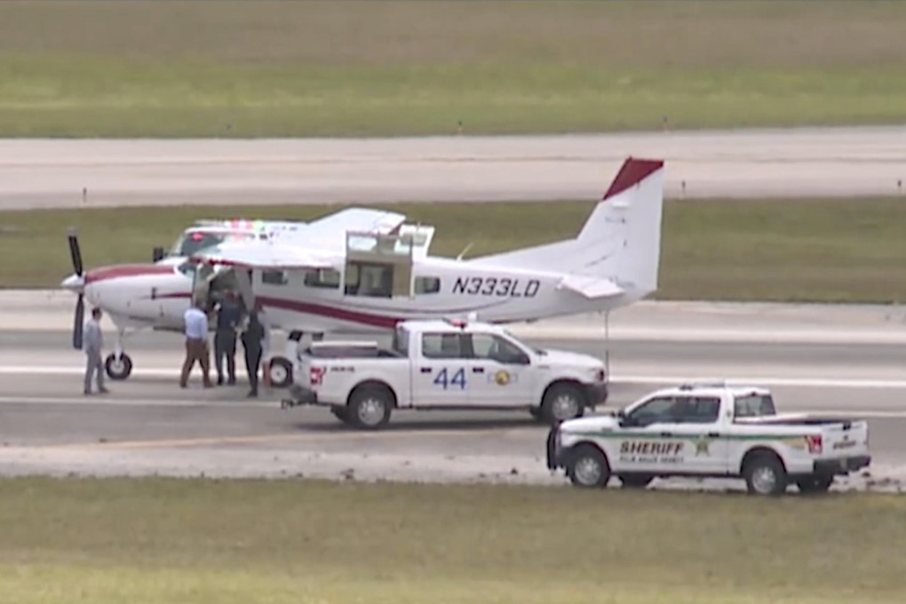 Emergency personnel surround a Cessna plane at Palm Beach International Airport in Florida on Tuesday. Photo: WPTV via AP