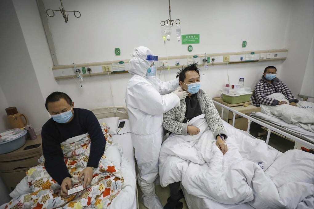 A doctor checks on patients at Wuhan’s Jinyintan Hospital, designated for critical Covid-19 patients, during the early days of the pandemic in February 2020. Photo: AP
