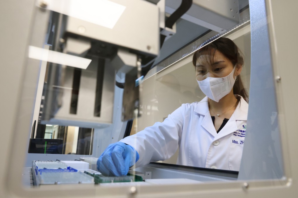A researcher uses automated equipment for high-throughput screening, a process which allows for the mass testing of chemicals, at the Centre for Chinese Herbal Medicine Drug Development, at Hong Kong Science Park, on December 22, 2021. Photo: Dickson Lee