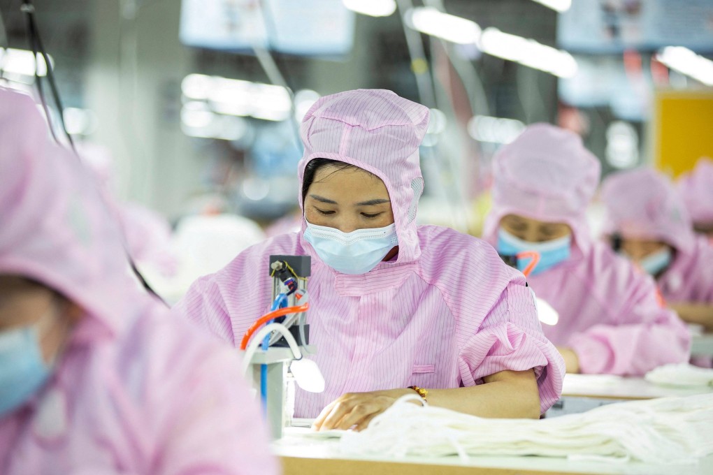 Workers produce face masks for export at a factory in Haian, in China’s eastern Jiangsu province. Photo: AFP
