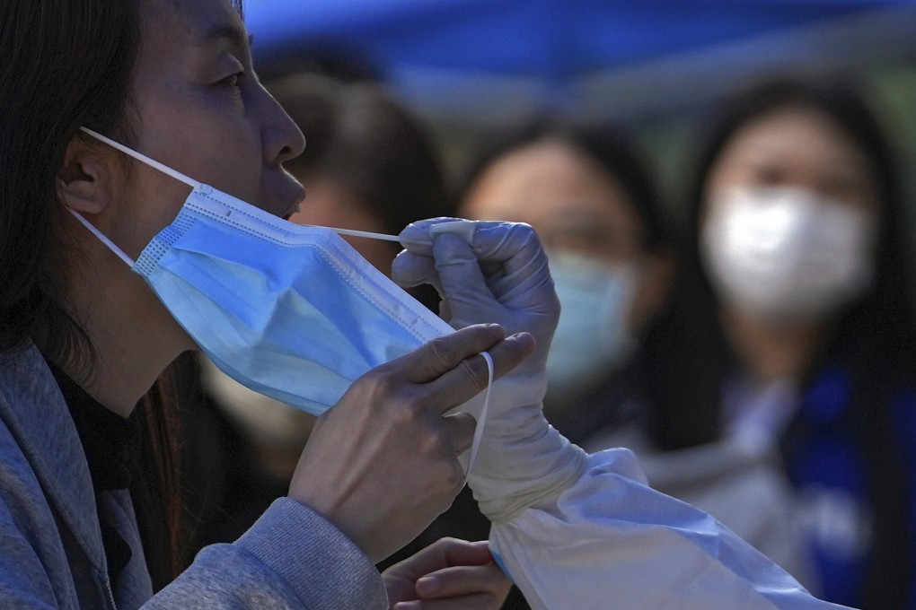 A woman gets tested in Chaoyang, one of several districts in Beijing where tighter restrictions are in place. Photo: AP