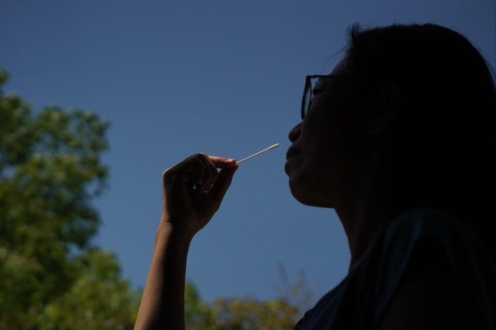 A woman self-tests for Covid-19 using a rapid antigen test, or RAT, on April 8. Photo: Felix Wong