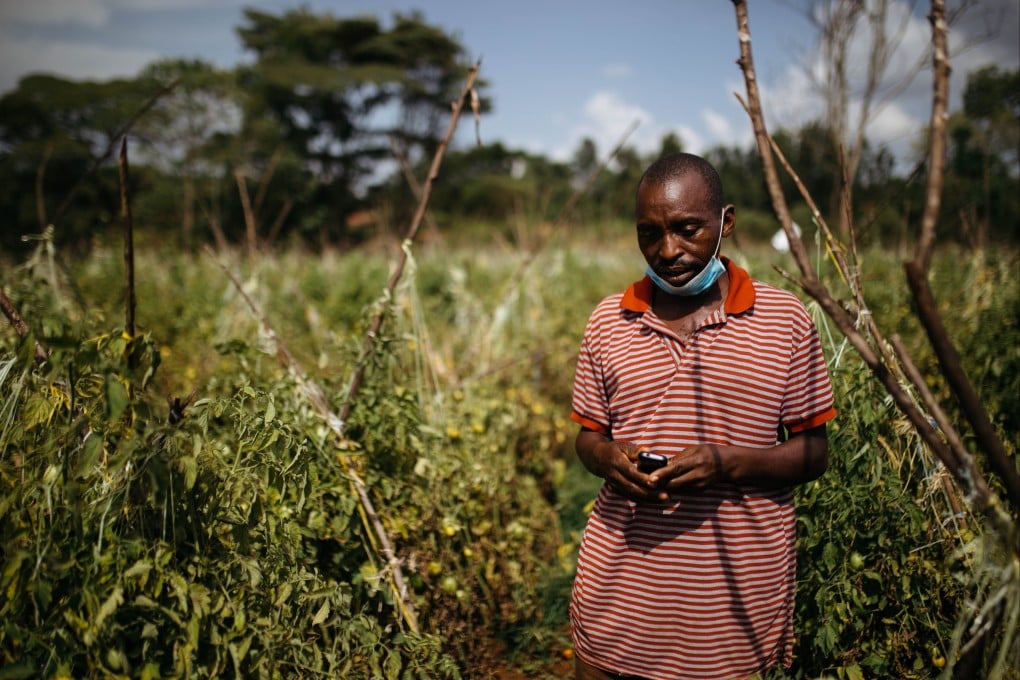Joel Mukungi uses a Chinese Itel Mobile phone on his farm in Kenya in February 2022. Photo: Kang-Chun Cheng
