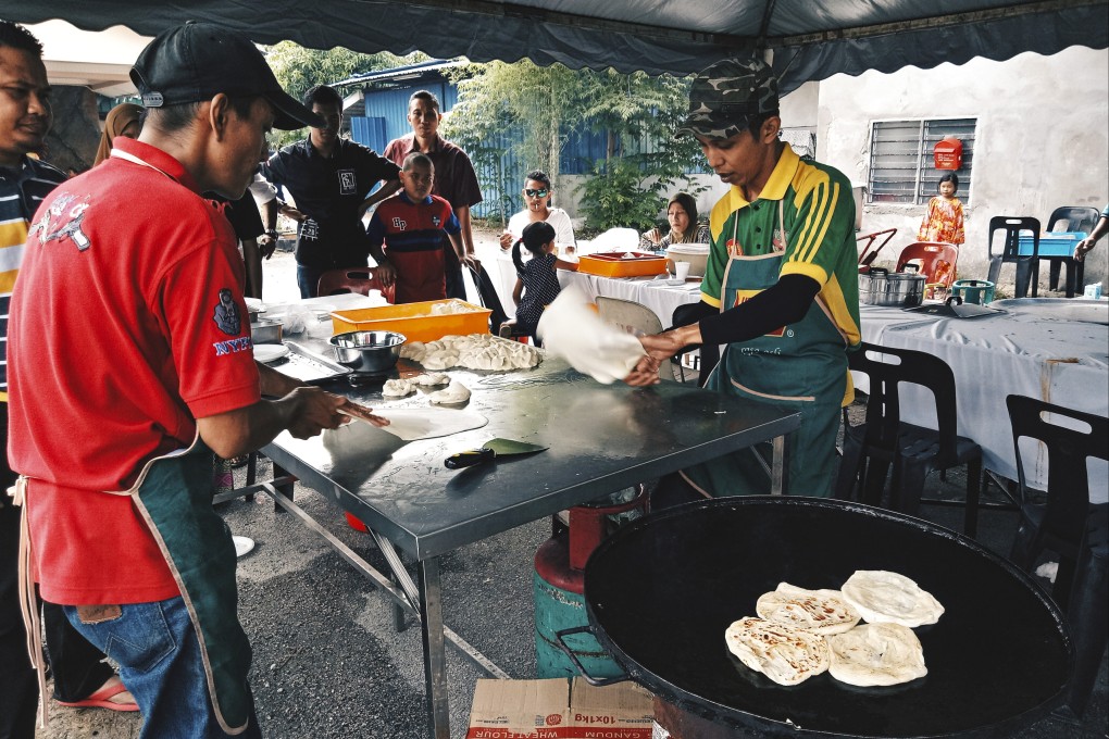 A vendor prepares roti canai terbang at a stall in Malaysia. The Indian flatbread, served griddled and often eaten with curry and sambal, is ubiquitous in hawker centres across Singapore and Malaysia. Photo: Shutterstock