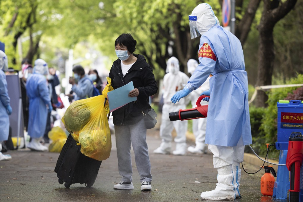 A woman is disinfected as she returns home to Shanghai’s Pudong New Area last month after being quarantined because of local Covid-19 cases. Photo: Xinhua via AP