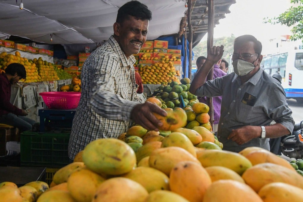 A customer buys mangoes at a stall in Bangalore, India. Photo: AFP