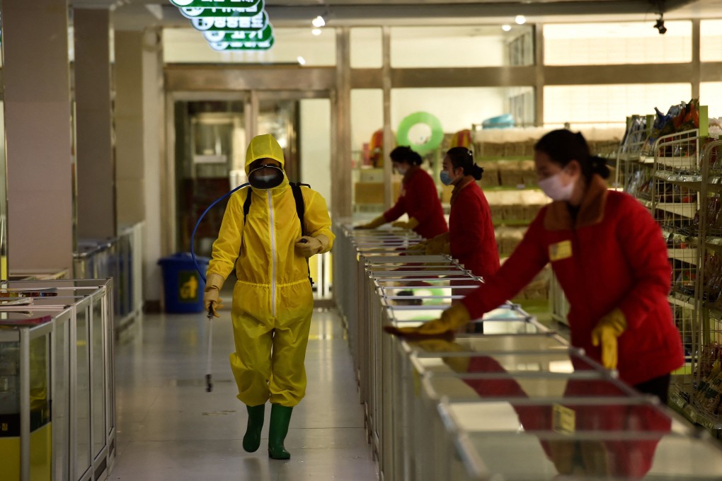 Employees spray disinfectant and wipe surfaces as part of preventive measures against Covid-19 at the Pyongyang Children’s Department Store in March. Photo: TNS