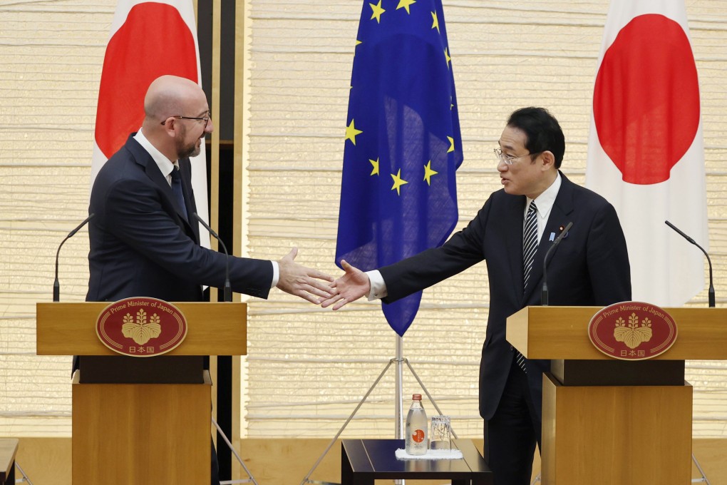 European Council President Charles Michel shakes hands with Japanese Prime Minister Fumio Kishida after a press conference in Tokyo on Thursday. Photo: Kyodo
