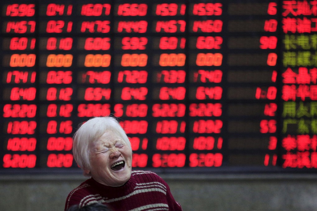 An investor at a brokerage house in Shanghai on March 7, 2016. Contrary to global conventions, China’s stock market represents gains and advances in red, using the green colour to denote losses and declines. Photo: Reuters