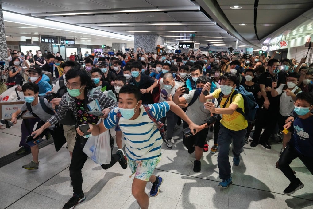 Avid train fans make a dash for the platform at Exhibition Centre station. Photo: Sam Tsang
