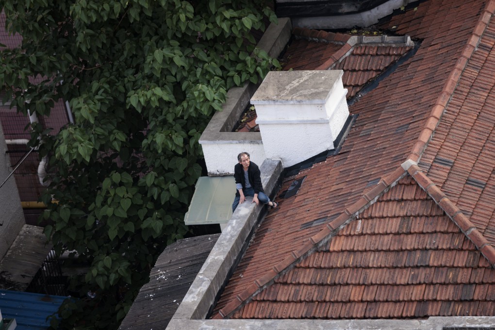 A man sits on the roof of his home in Shanghai. Residents of lockdown zones in Yangpu district, the location of many of Shanghai’s universities, are under a three-day ‘silent period’ and are confined to their homes to ensure zero contact with outsiders. Photo: EPA-EFE