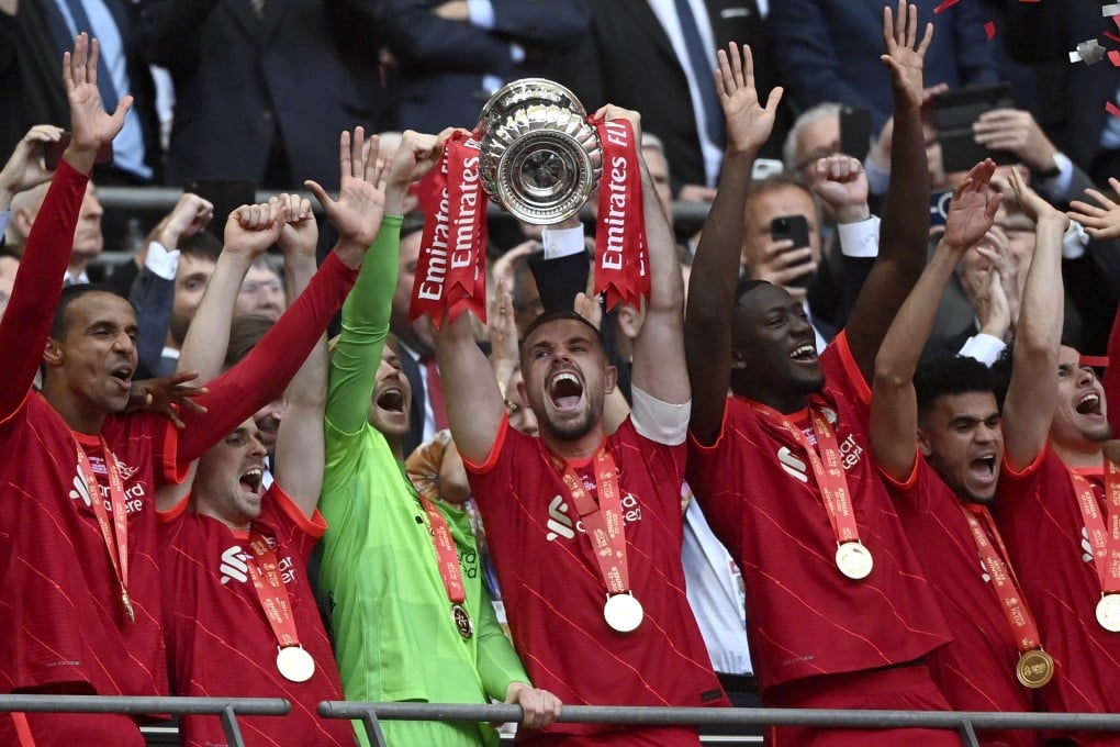 Jordan Henderson lifts the trophy as Liverpool celebrate after winning the FA Cup final against Chelsea at Wembley. Photo: EPA-EFE