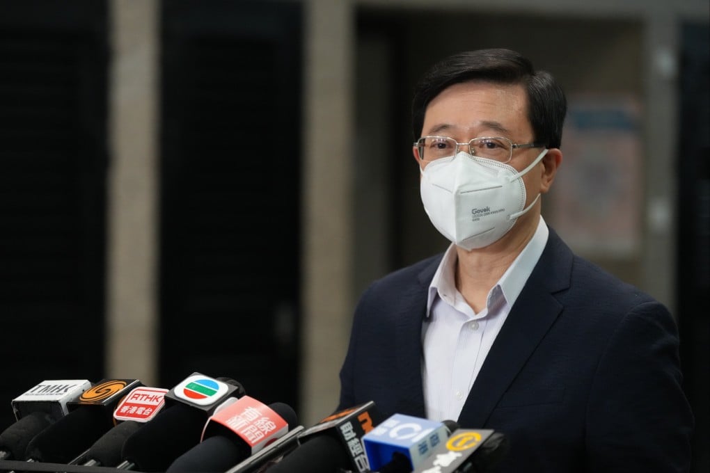 John Lee signing a statutory declaration at the Immigration Tower in Wan Chai. Photo: Sam Tsang