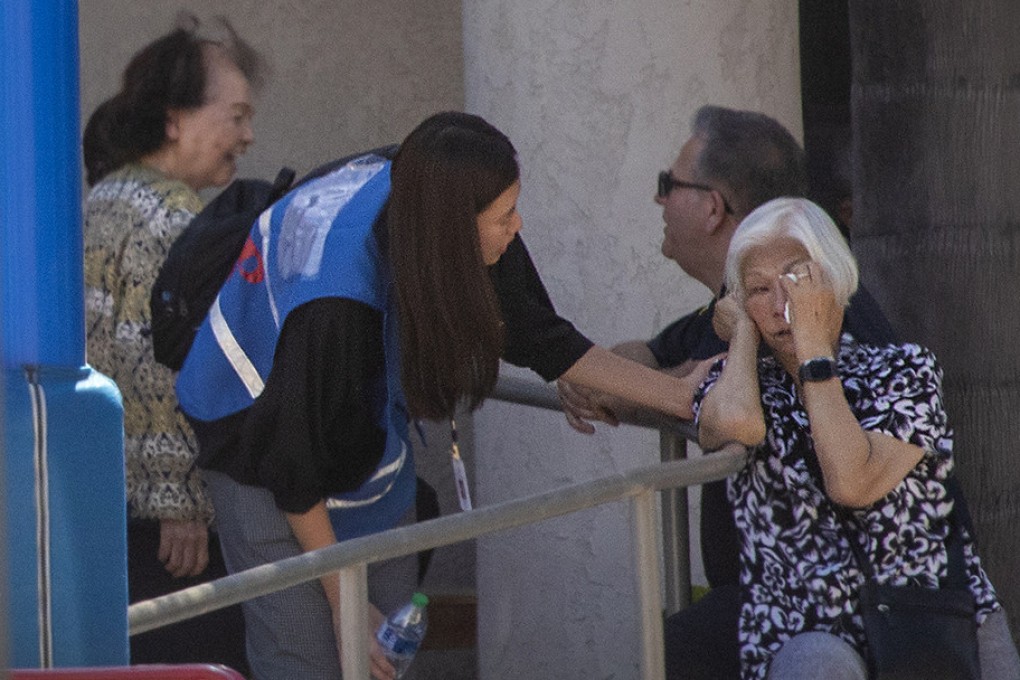 A first responder grief counselor comforts a parishioner after a person opened fire during a church service attended by a Taiwanese congregation in Laguna Woods, Southern California. Photo: TNS