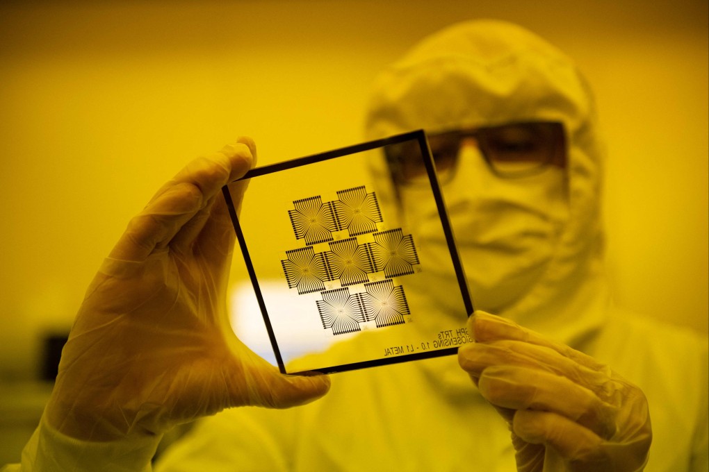 An employee inspects chips in the clean room of the Barcelona Institute for Microelectronics, March 3, 2022. - Photo: AFP
