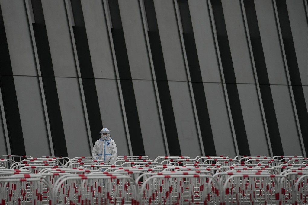 A worker in a protective suit stands watch near the barricades at a testing site as the authorities order a third round of coronavirus tests for residents of Beijing’s Chaoyang district on May 8. Photo: AP