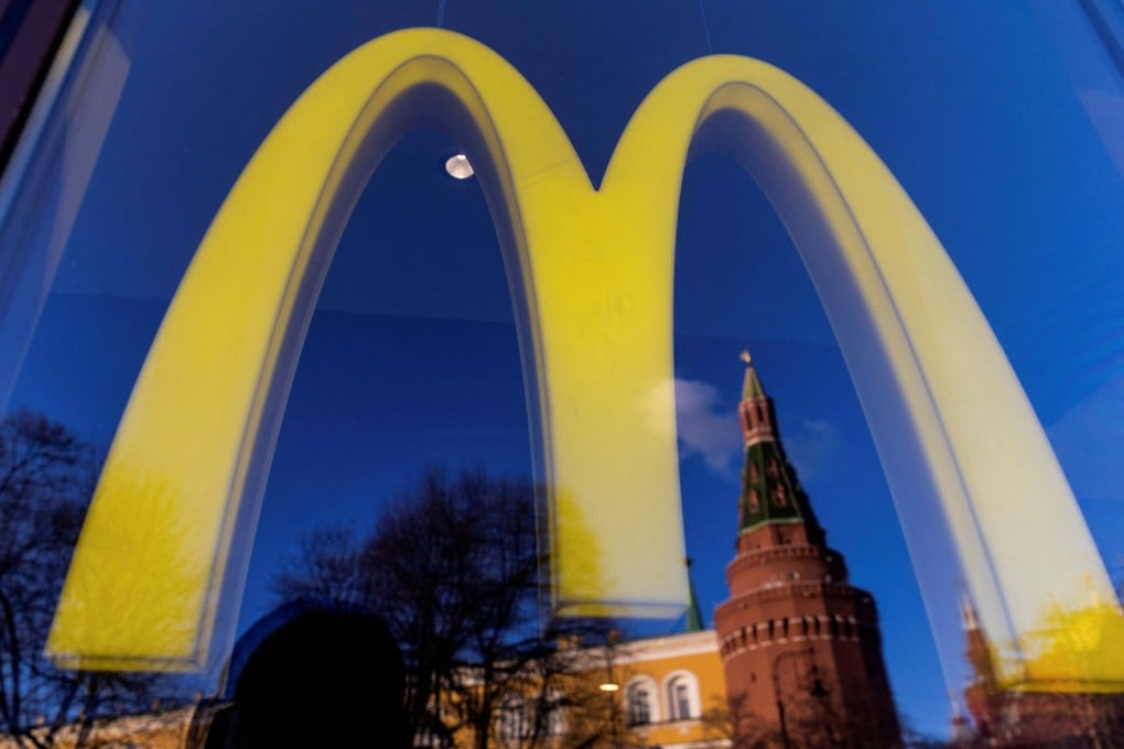 A logo of the McDonald’s restaurant and the Kremlin’s tower seen through a window. Photo: Reuters