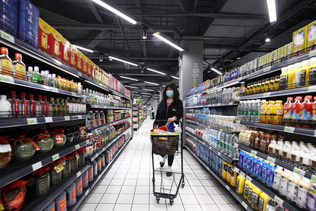A customer at a supermarket that reopened in Shanghai on May 16, 2022 amid declining infections. Photo: VCG