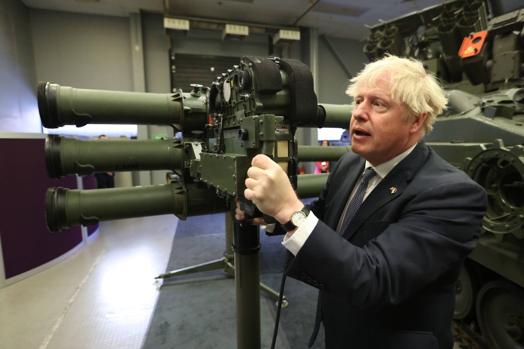 Britain’s Prime Minister Boris Johnson looks at a Mark 3 shoulder launch LML (Lightweight Multiple Launcher) missile system at the Thales weapons manufacturer in Belfast on Monday. Photo: AP