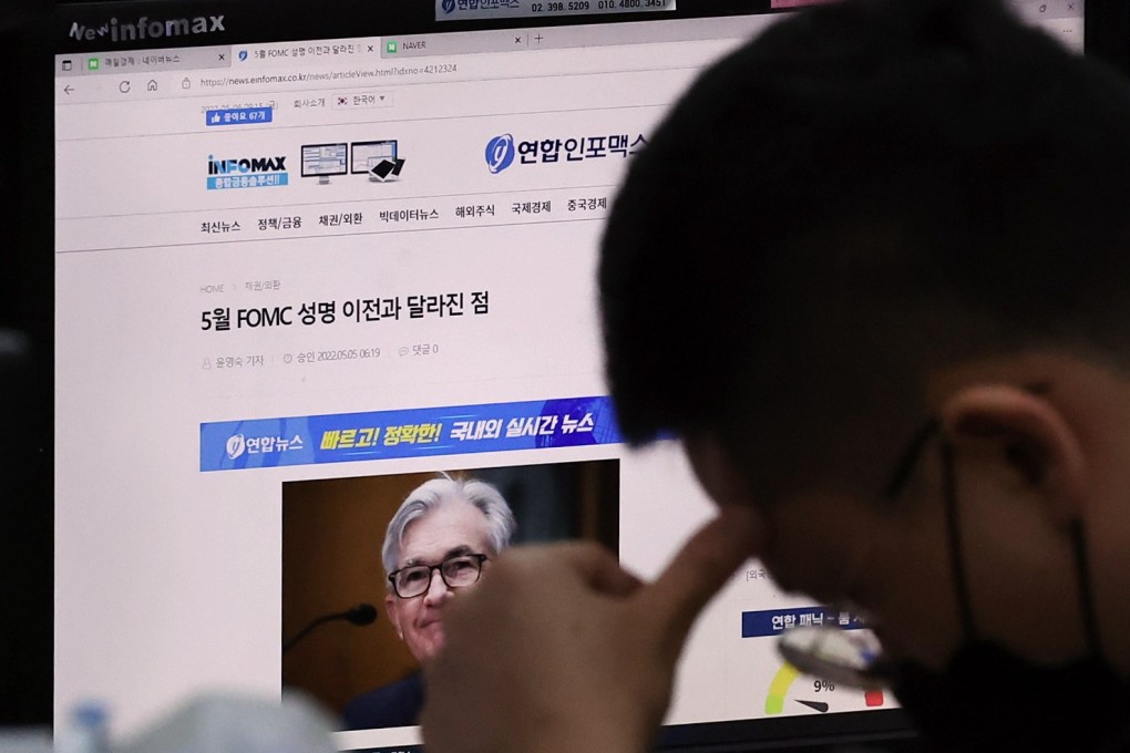A currency trader in Seoul, South Korea, reads a news report on the US Federal Reserve’s decision to raise key interest rates, on May 6. Photo: EPA-EFE