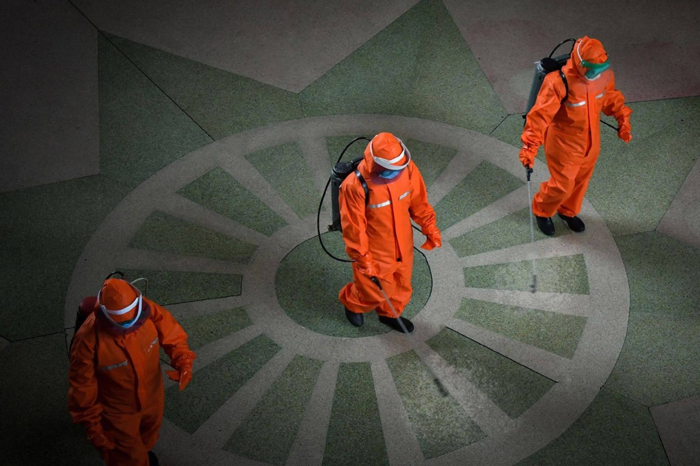 Railway station staff disinfecting Pyongyang station premises as a prevention measure against the Covid-19 coronavirus. Photo: AFP