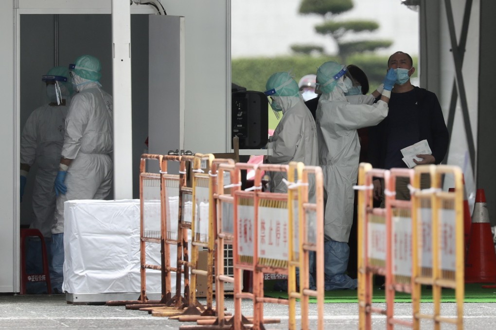 People get tested at a makeshift facility next to the Chiang Kai-shek Memorial Hall in Taipei on Wednesday. Photo: EPA-EFE