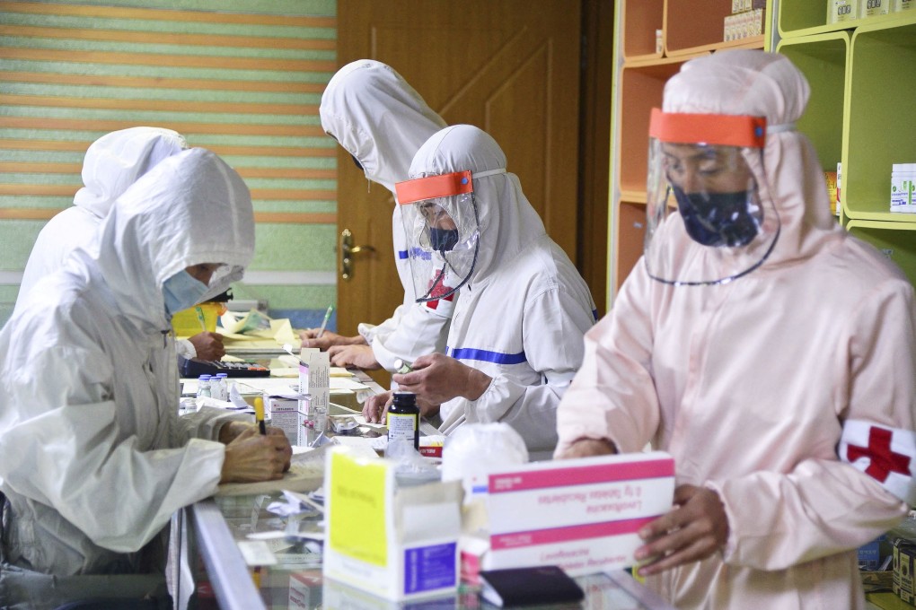 North Korean soldiers distribute medicines at a pharmacy in Pyongyang on Wednesday amid growing fears over North Korea’s Covid-19 outbreak. Photo: Kyodo via Reuters