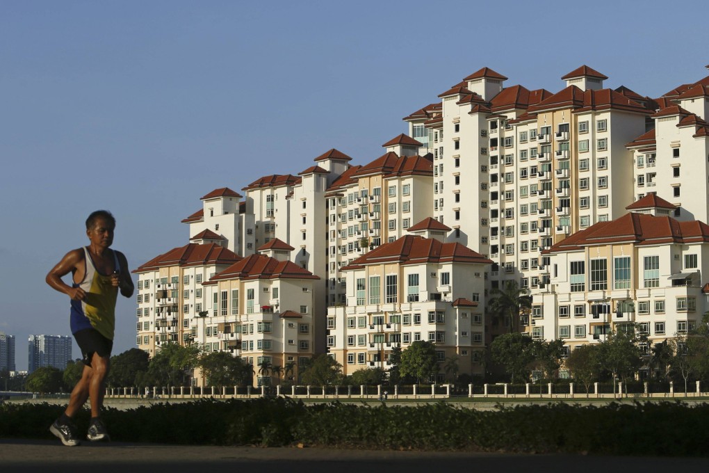 A man jogs past a condominium at Tanjong Rhu in Singapore. Photo: Reuters