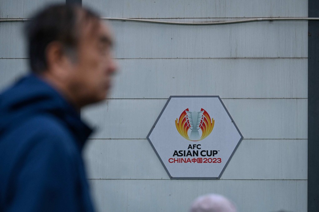 A man walks past signage for the 2023 Asian Cup in Beijing. China has withdrawn from hosting the tournament. Photo: AFP