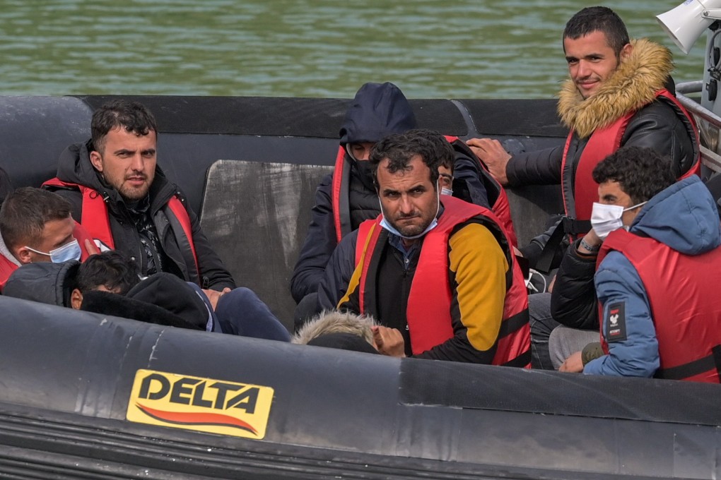 People arrive at Dover Docks after British Border Force Officials picked up a boat carrying migrants in the English Channel. Under a scheme designed to crack down on migrants landing on British shores after crossing the Channel in small boats, the UK intends to provide those deemed to have arrived unlawfully with a one-way ticket to Rwanda. Photo: EPA-EFE