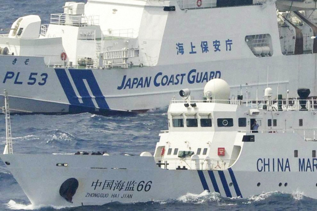 A Japanese coastguard ship patrols close to a Chinese marine surveillance vessel, near the disputed Diaoyu Islands, which are called the Senkaku Islands in Japan. Photo: Kyodo News