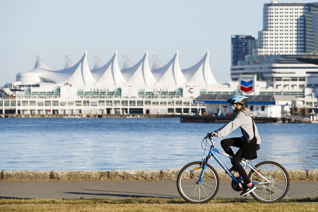 As Covid-19 restrictions ease around the world, Asian-Canadian millennials talk about their future travel plans. Above: a woman cycles along the seawall at Stanley Park in Vancouver, Canada. Photo: Andrew Chin/Getty Images