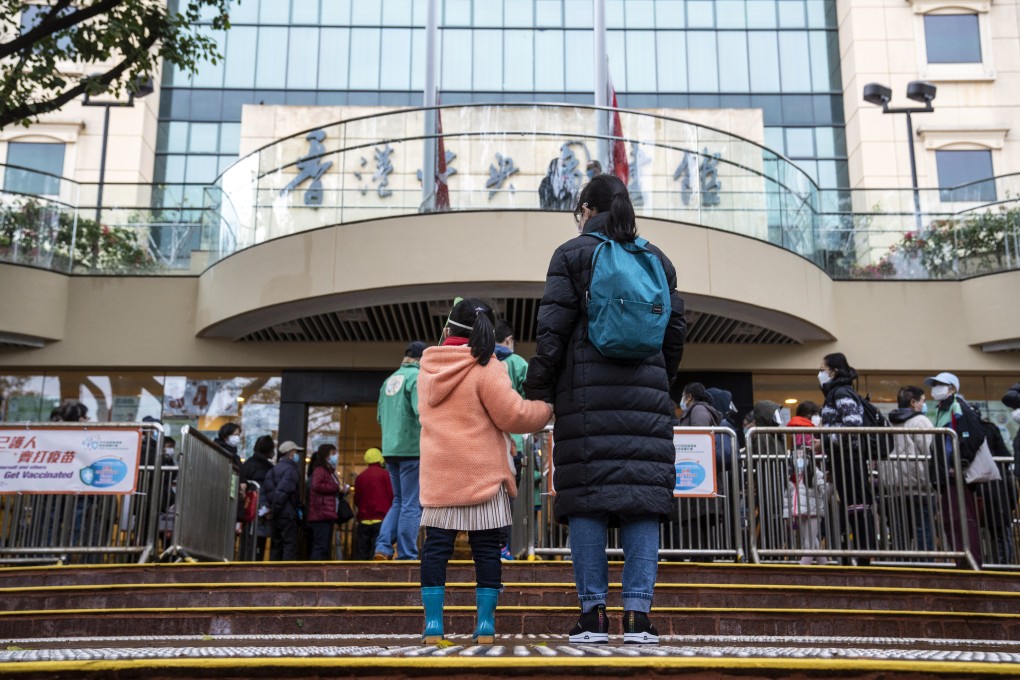 Residents queue for vaccinations in Hong Kong in February. As the third phase of the Covid-19 vaccine pass scheme looms, there is a rush to get inoculated by the deadline. Photo:  Bloomberg