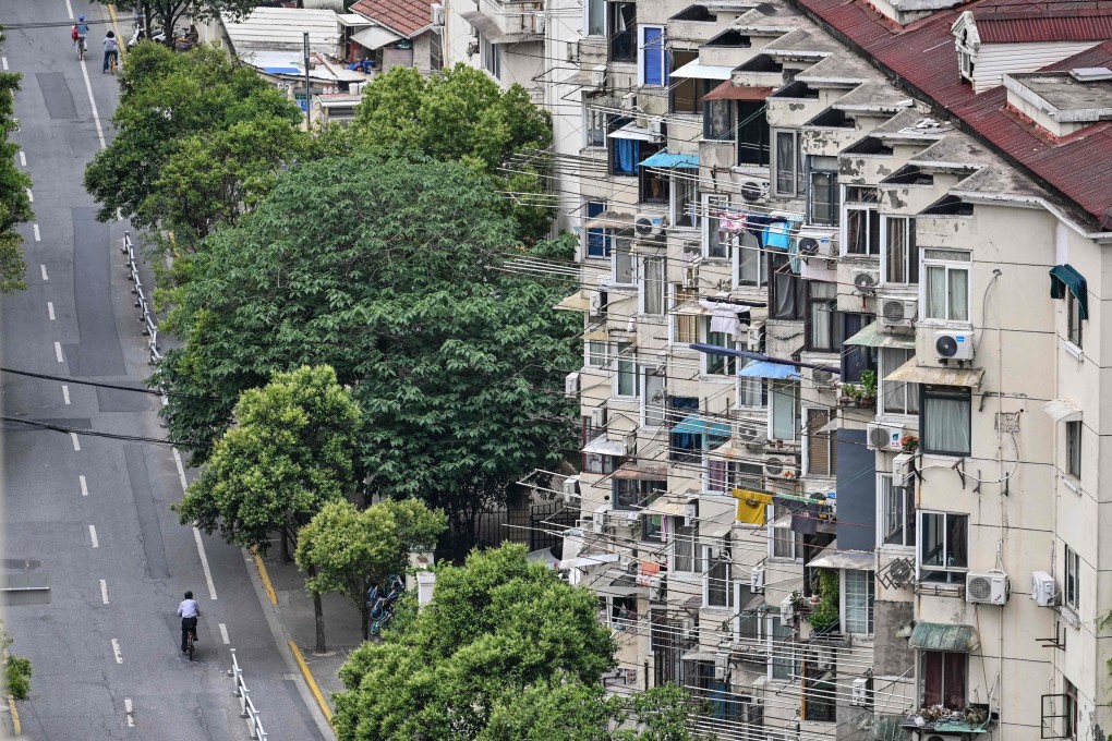 A lone cyclist on a near-empty street during a Covid-19 coronavirus lockdown in the Jing’an district in Shanghai on May 19, 2022. Photo: AFP