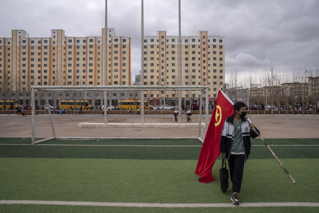 A student with the flag of China’s Communist Youth League, which celebrated its centenary on May 10, 2022. Photo: Bloomberg