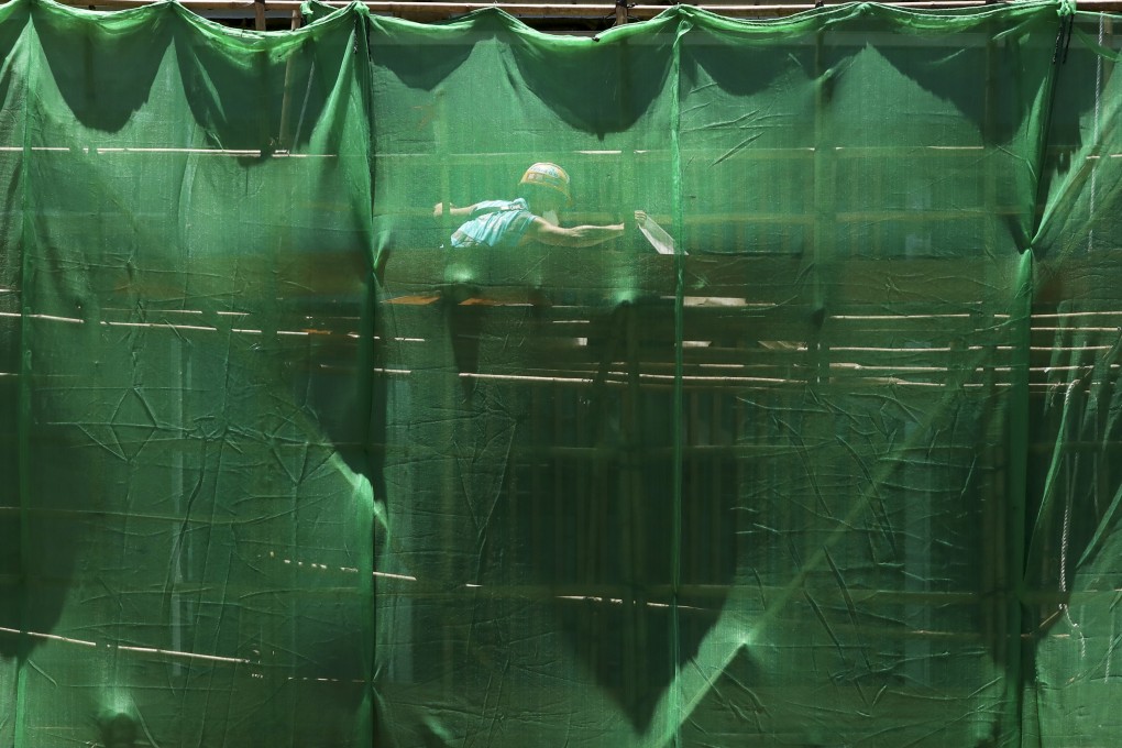 A construction worker toils in the sun at Allegro property development in Kowloon City on May 19, 2022. Photo: Jonathan Wong
