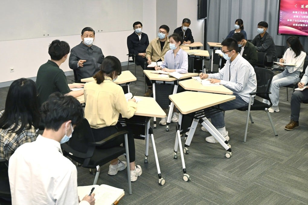 President Xi Jinping sits with students during a visit to Renmin University of China in Beijing on April 25. Photo: Xinhua