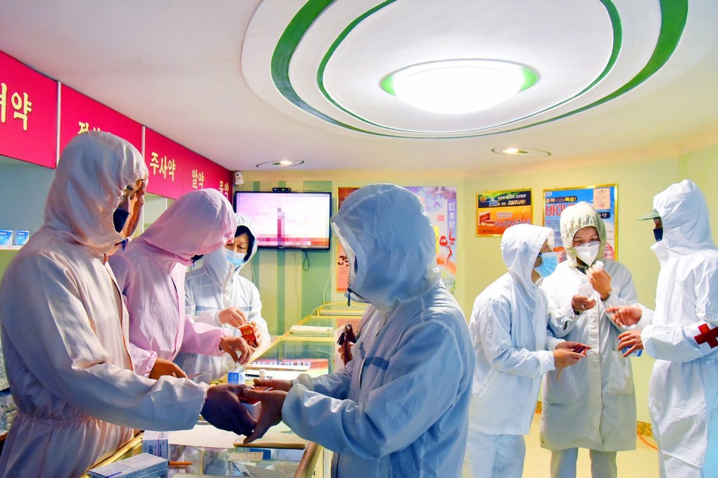 North Korean medical service personnel in handing out medication at a pharmacy to curb the coronavirus health crisis. Photo: EPA-EFE