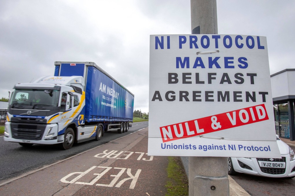 A lorry passes an anti-‘Northern Ireland Protocol’ sign as it leaves a port near Belfast this month. Photo: AFP