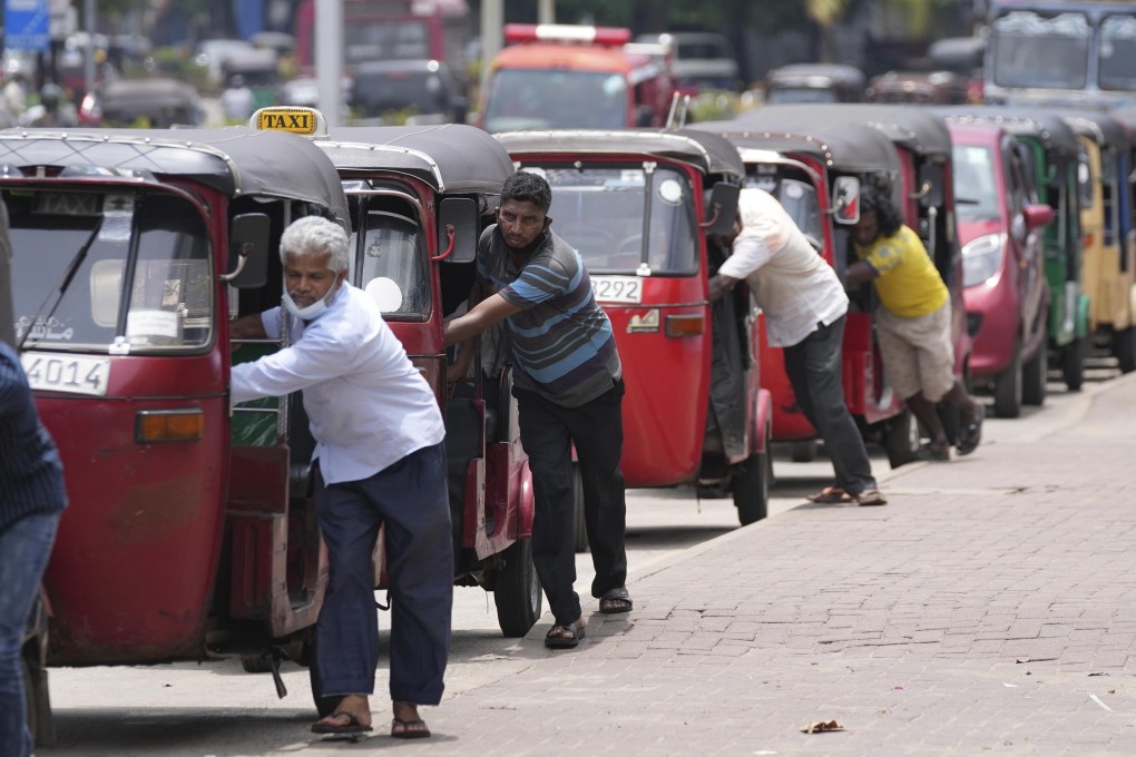 Sri Lankan auto rickshaw drivers queue up to buy petrol in Colombo on April 13. The country’s financial crisis has become so severe it cannot import food or gasoline. Photo: AP