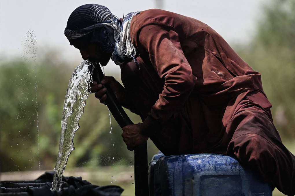 A man drinks water from a pipe in Jacobabad earlier this month amid the intense heatwave sweeping Pakistan and India. Photo: AFP
