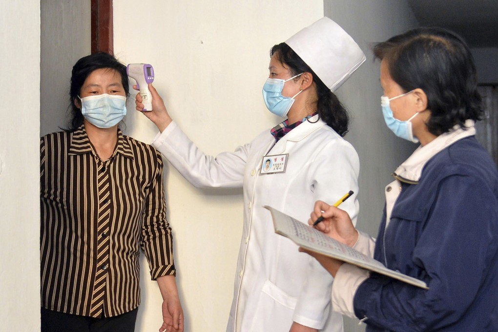 A woman has her temperature checked in Pyongyang earlier this month as an antivirus measure. Photo: Korean Central News Agency/Korea News Service via AP