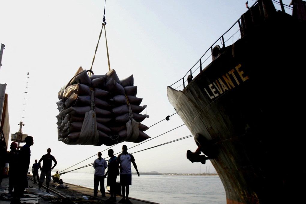 Port workers watch as a crane lifts sugar sacks on the docks at Brazil’s main ocean port in Santos. Photo: Reuters